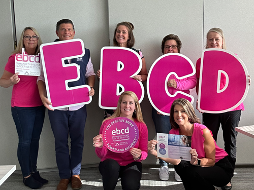 Community members spreading breast cancer awareness at a local event