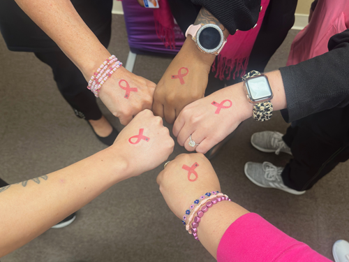 Community members spreading breast cancer awareness at a local event