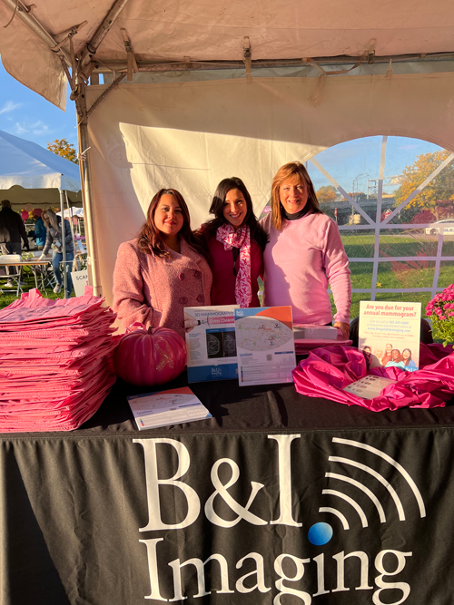 Community members spreading breast cancer awareness at a local event