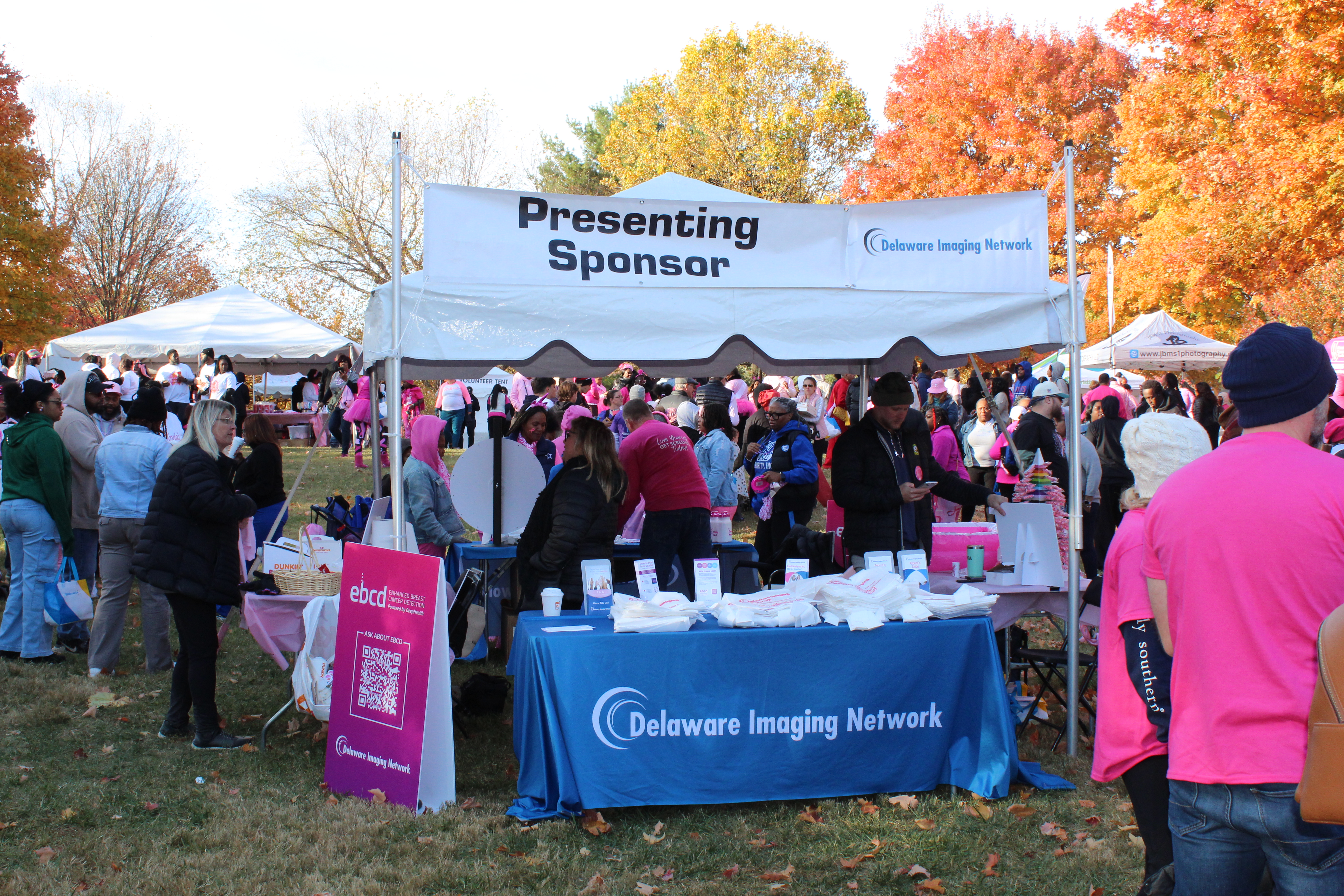 Community members spreading breast cancer awareness at a local event