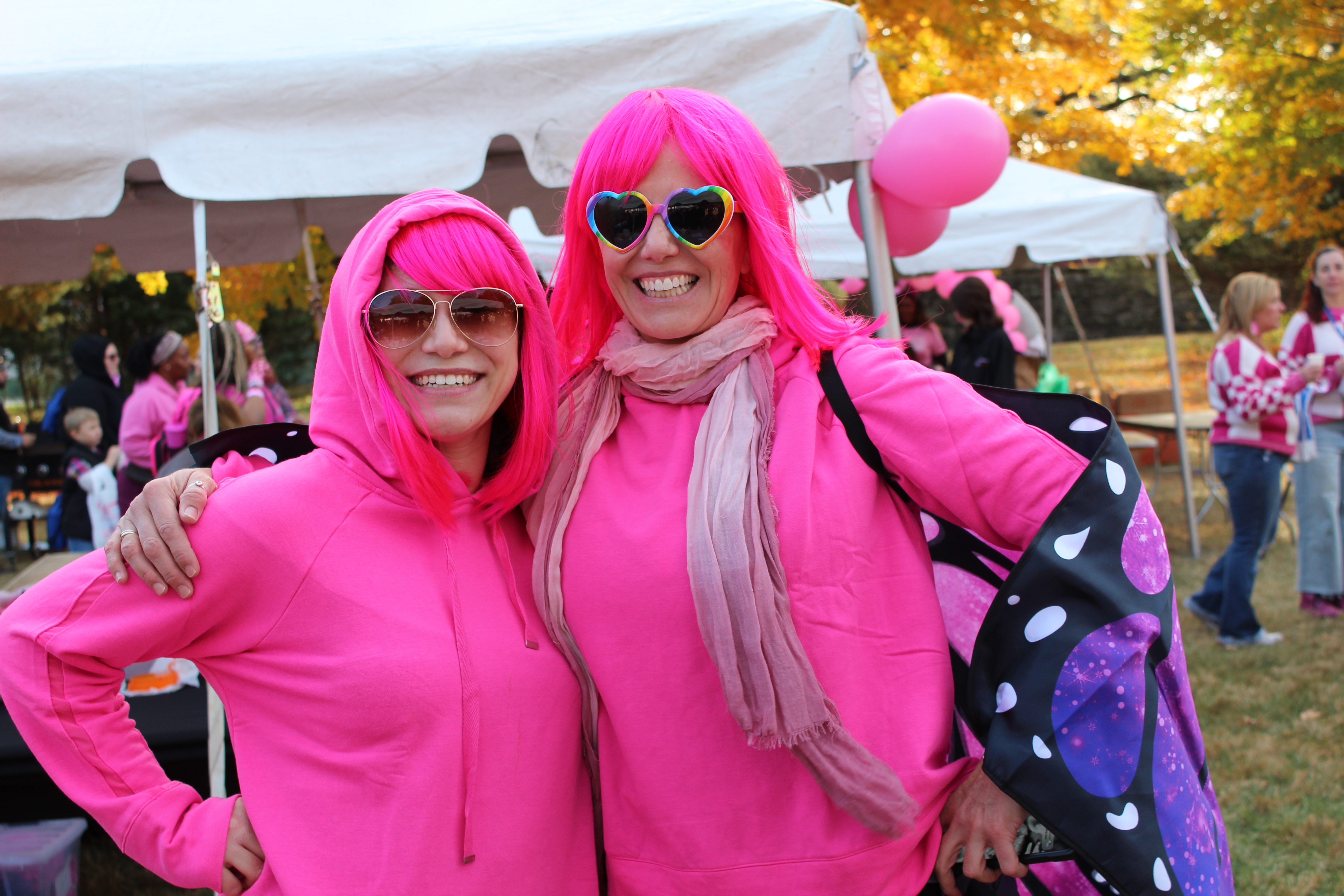 Community members spreading breast cancer awareness at a local event