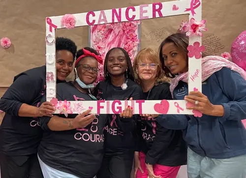 Community members spreading breast cancer awareness at a local event