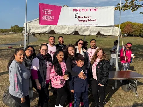 Community members spreading breast cancer awareness at a local event