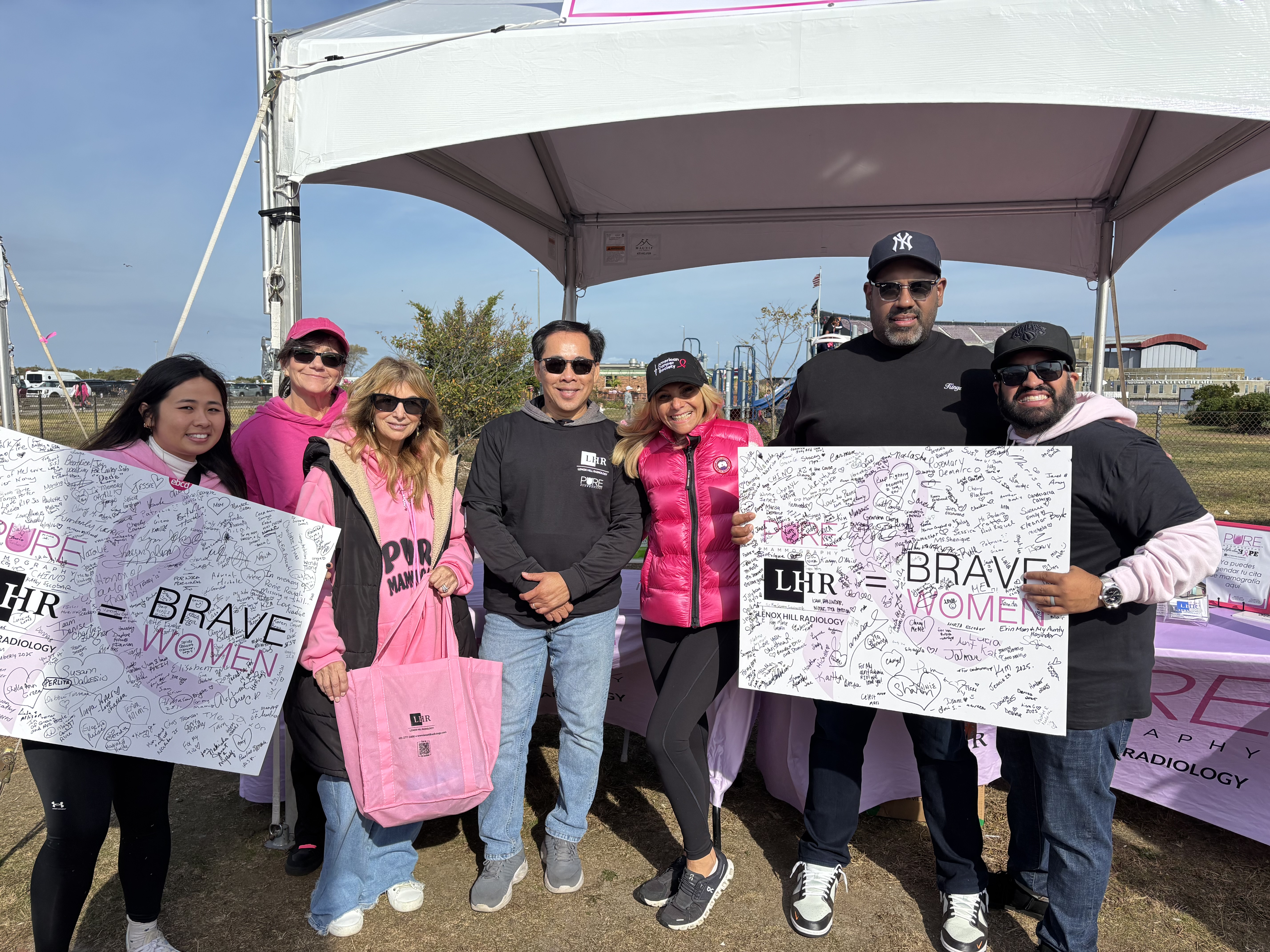 Community members spreading breast cancer awareness at a local event