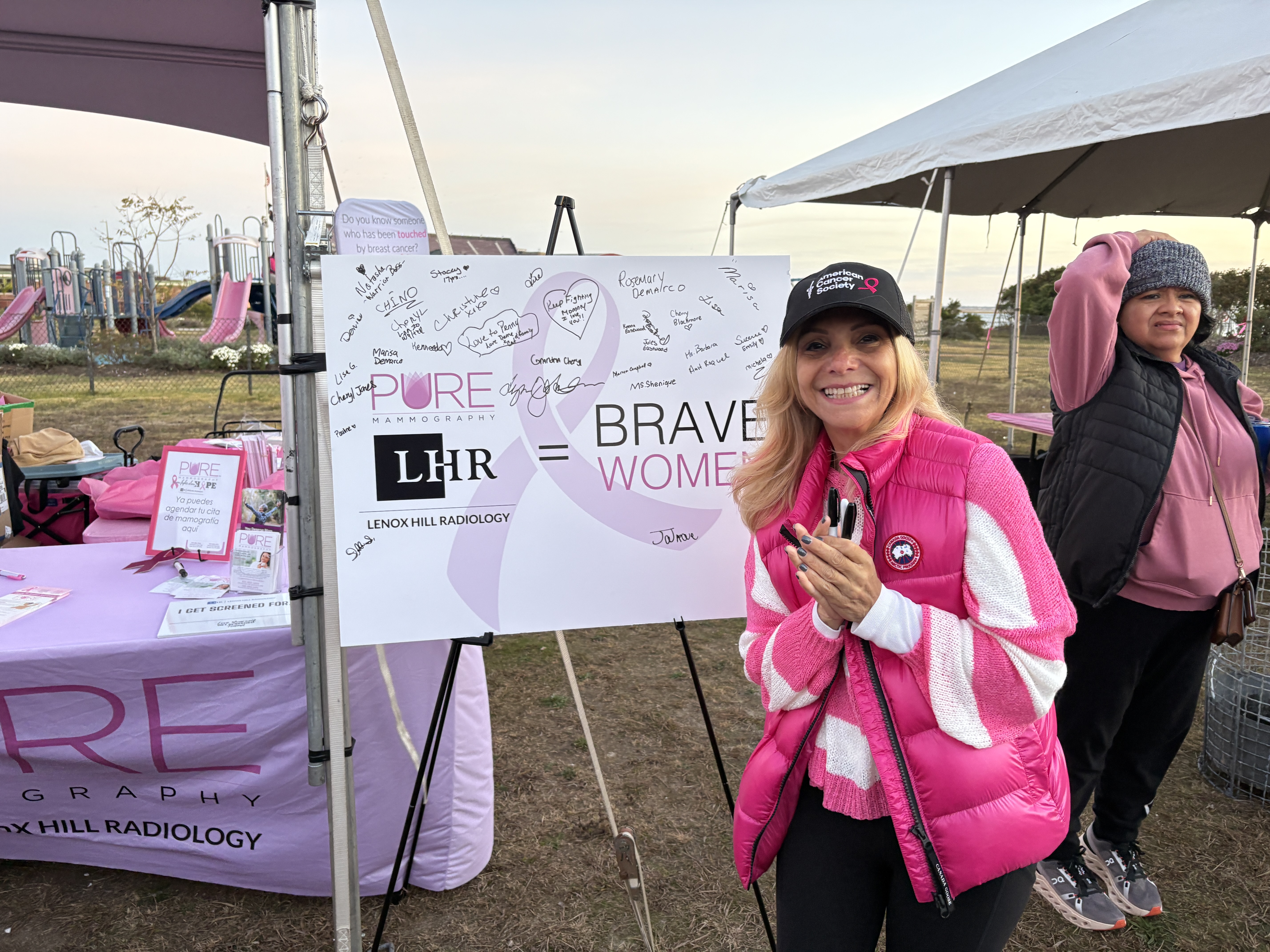 Community members spreading breast cancer awareness at a local event