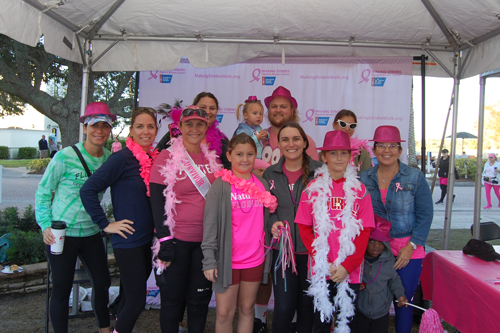 Community members spreading breast cancer awareness at a local event