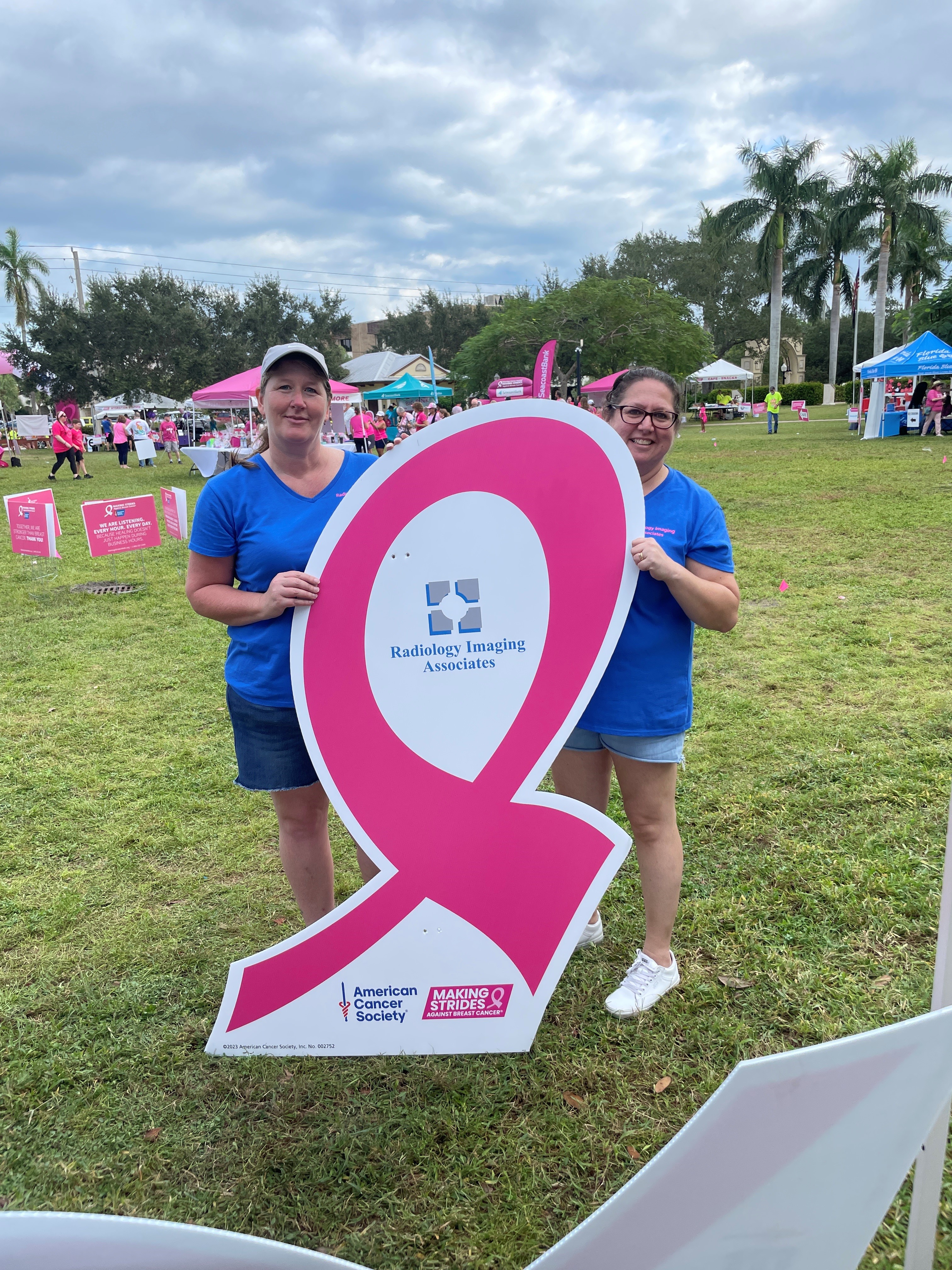 Community members spreading breast cancer awareness at a local event